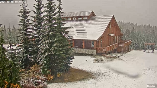 Snow is falling on Mount Washington while storm lashes Island